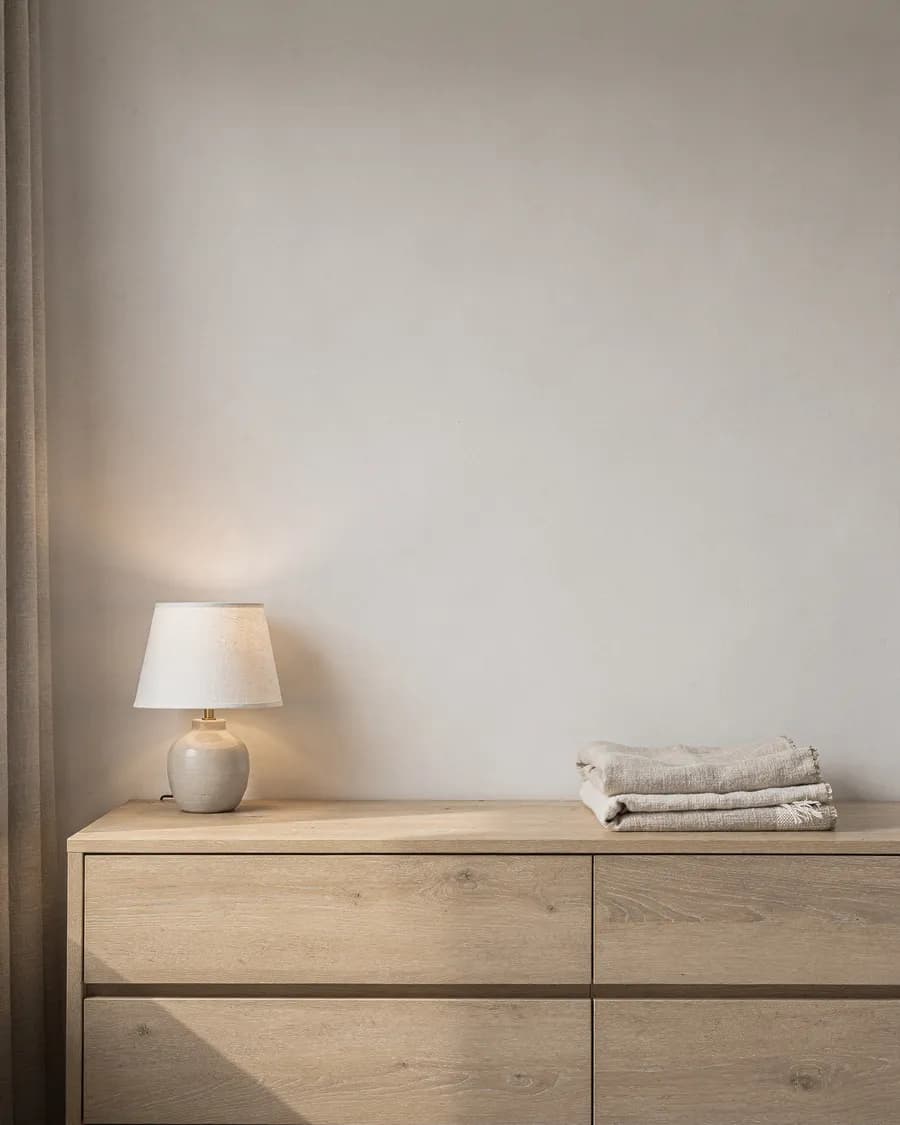 Bedroom wall above a light-oak dresser